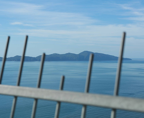 image of a barrier with Kapiti Island in the distance