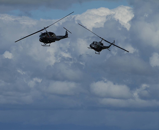 two army helicopters in a chase